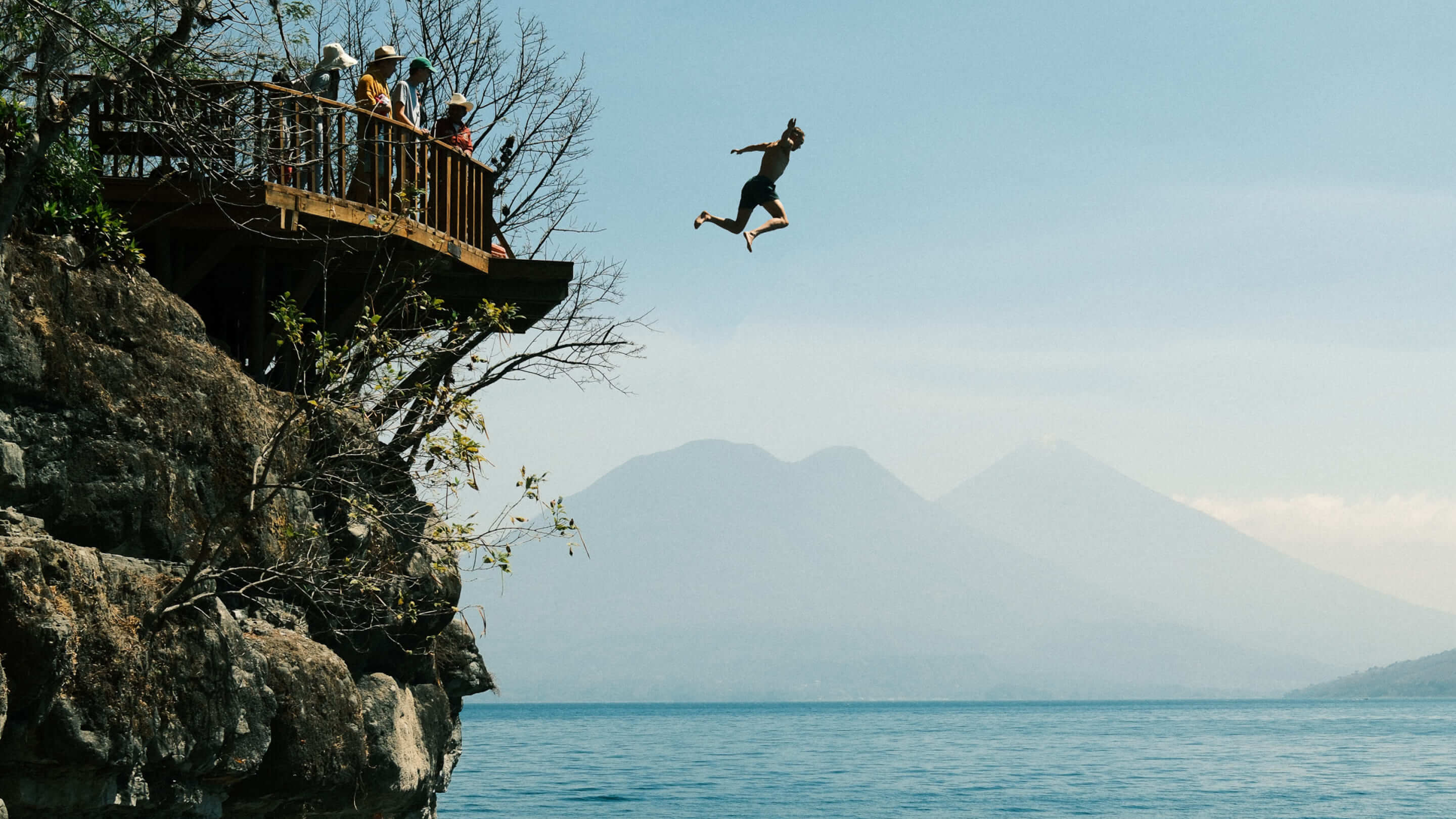 Person jumping into the ocean from a cliff
